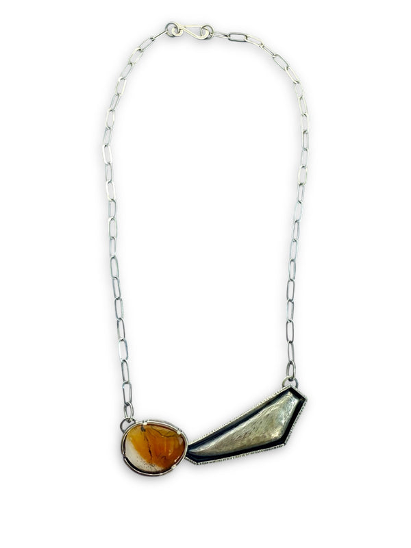 Necklace with asymmetrical pendant on a white background